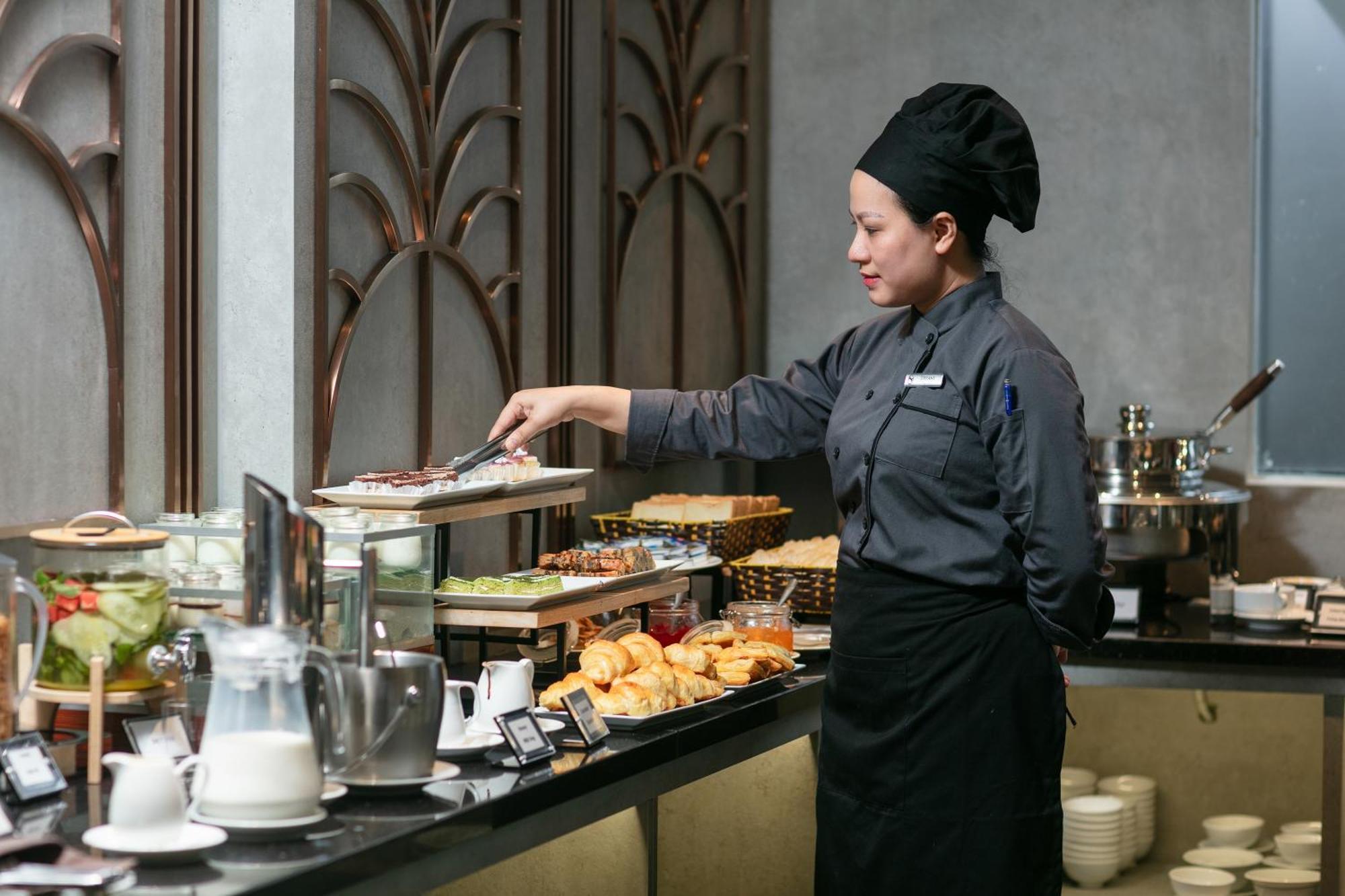 May De Ville Crown Hotel Hanoi Eksteriør billede A cook at work